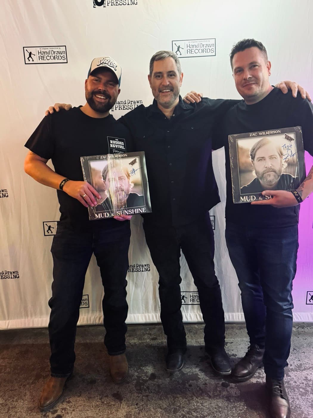 TJ and Rugged Ronnie with Zac Wilkerson holding his Mud & Sunshine vinyl